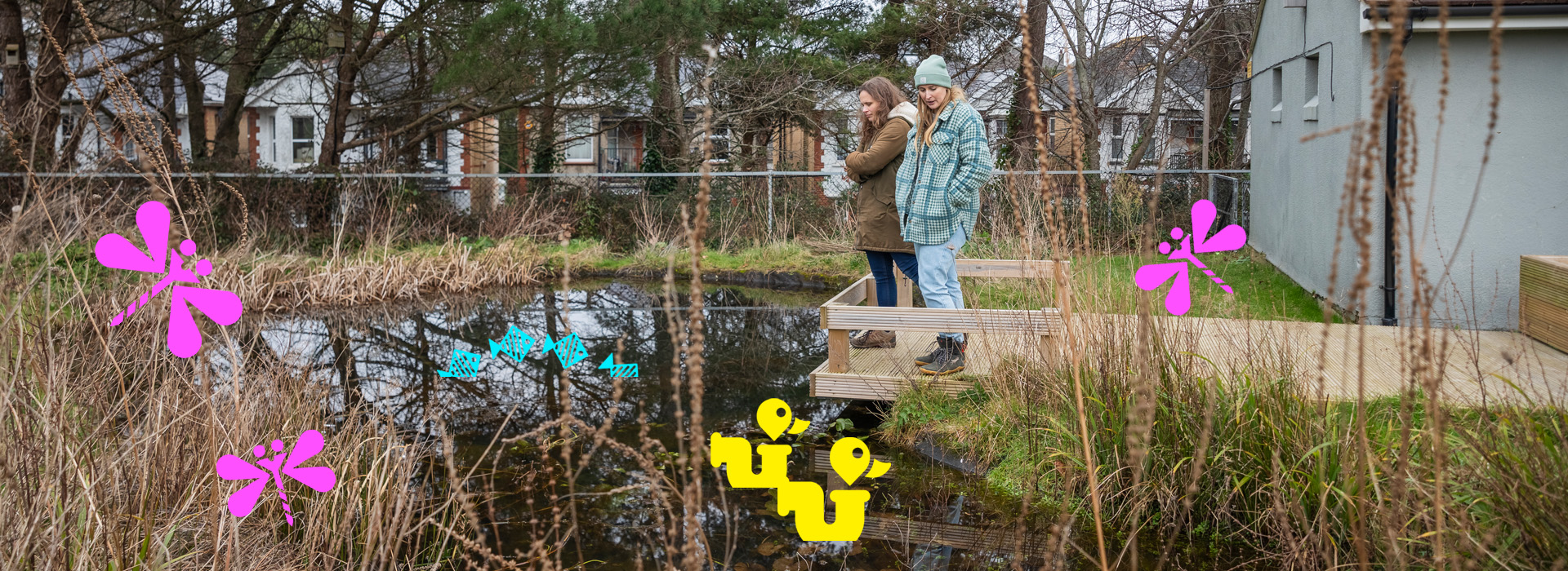 Two people standing on wooden viewing platform looking into a wildlife pond with Nature Towns and Cities urban nature icons.